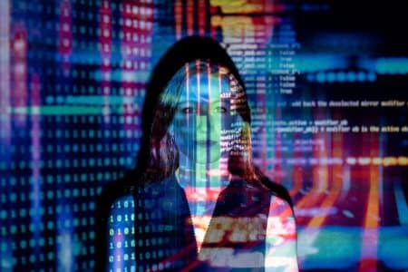 Ces nouvelles technologies qui révolutionnent les casinos sans que vous le sachiez A woman with digital code projections on her face, representing technology and future concepts.